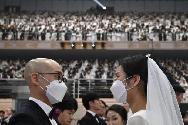 In sickness and in health: Mass wedding defies new coronavirus fears