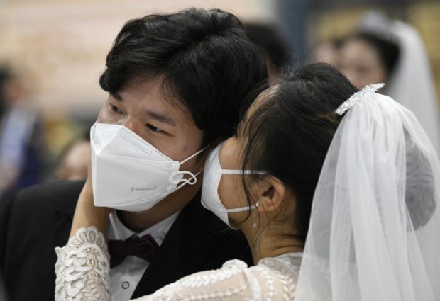 In sickness and in health: Mass wedding defies new coronavirus fears