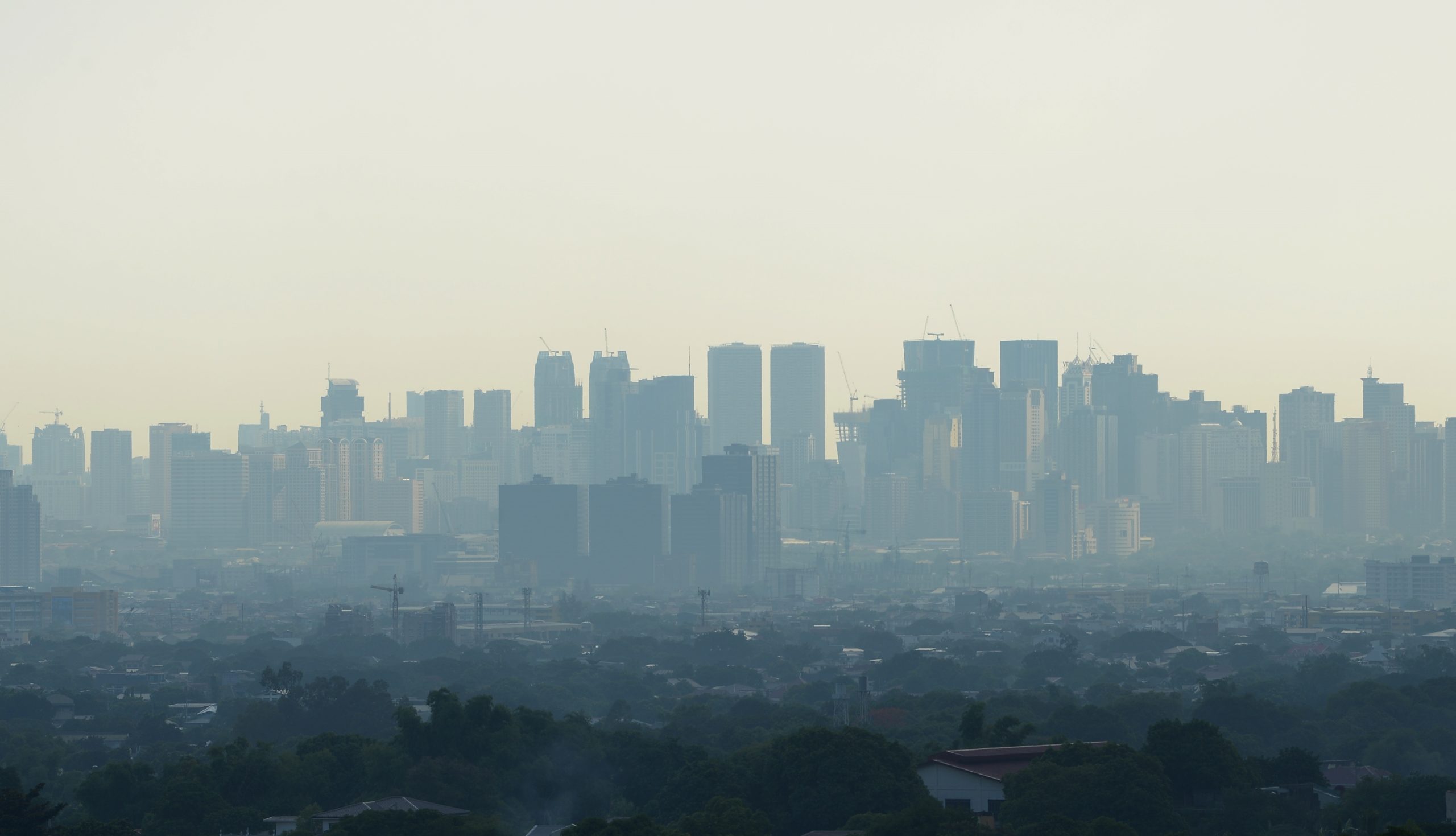 In this photo taken on June 23, 2019 shows smog covering buildings in Manila. (Photo by Ted ALJIBE / AFP)
