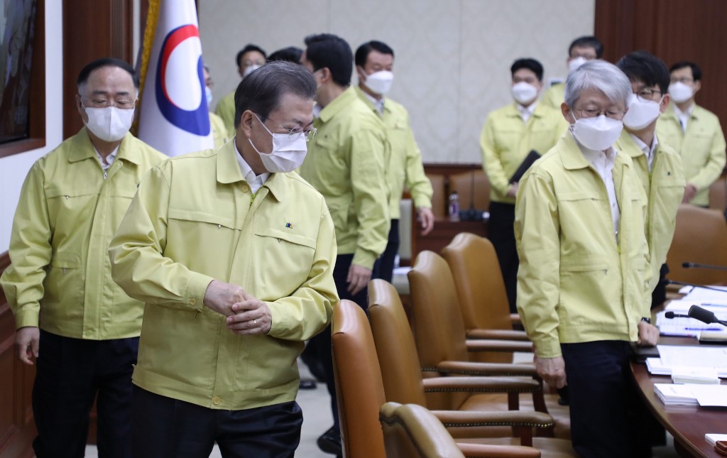 South Korean President Moon Jae-in (2nd L) and his ministers wearing face masks attend a cabinet meeting at the government complex in Seoul on March 3, 2020. - South Korea's coronavirus case total -- the largest in the world outside China -- approached 5,000 on March 3 as authorities reported 477 new cases. (Photo by - / YONHAP / AFP) / - South Korea OUT / REPUBLIC OF KOREA OUT  NO ARCHIVES  RESTRICTED TO SUBSCRIPTION USE