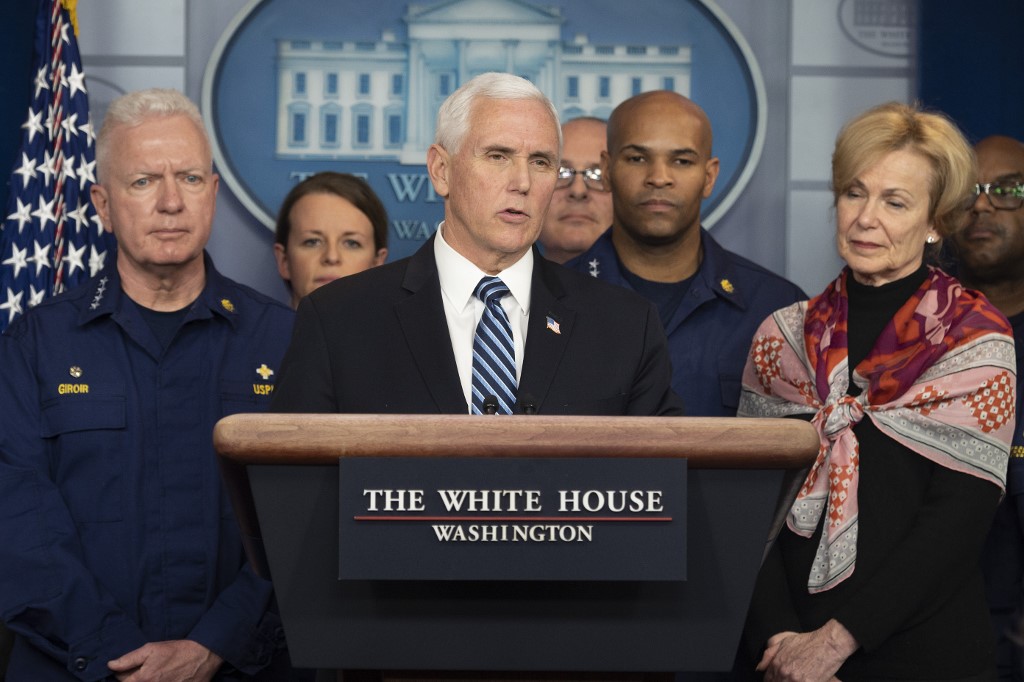(FILES) In this file photo taken on March 15, 2020 US Vice President Mike Pence, standing with members of the White House Coronavirus Task Force team, speaks during a press briefing in the press briefing room of the White House in Washington, DC. - A staff member of the office of US Vice President Mike Pence tested positive for the coronavirus, Pence's press secretary said on March 20, 2020. (Photo by JIM WATSON / AFP)