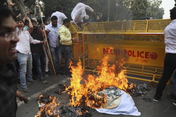 Congress party workers burn an effigy in India