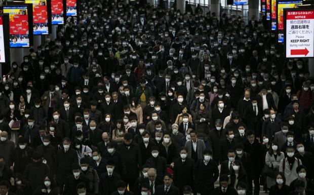 Commuters in Japan all wearing masks