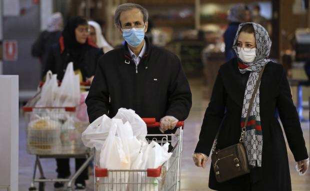 Shoppers wearing masks and gloves in Tehran
