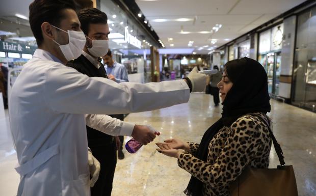 Woman having temperature checked in Tehran shopping center