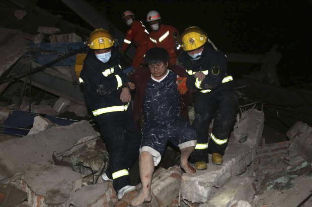  Rescuers help man in China hotel collapse