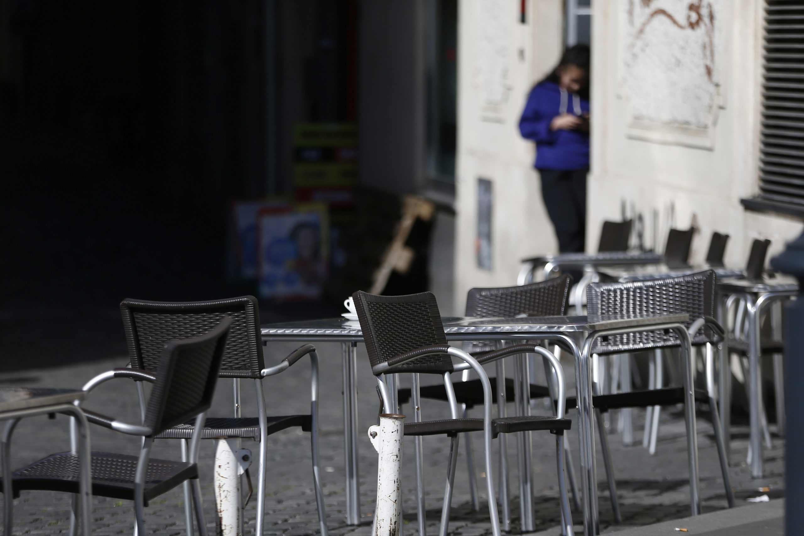Chairs are empty at a cafe in Largo Argentina square amid growing concern about the spread of a new coronavirus in Rome Saturday, March 7, 2020. Italy is taking an almighty hit to its already weak economy from being the focal point of the coronavirus emergency in Europe. (Cecilia Fabiano/LaPresse via AP)