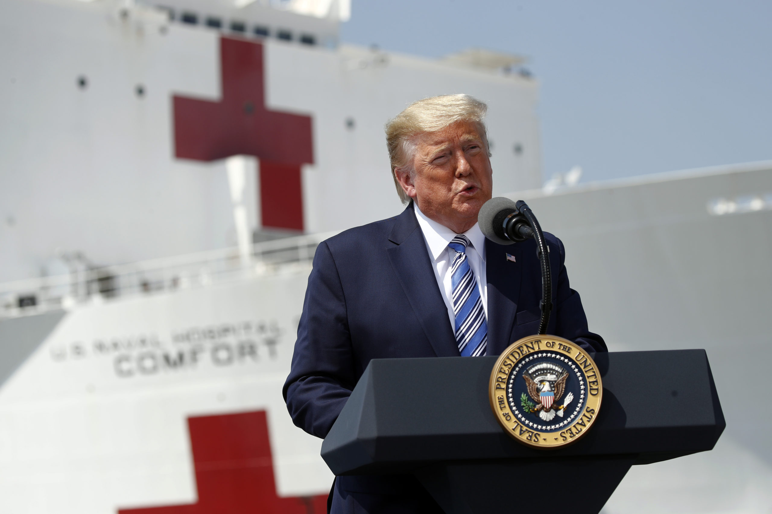 President Donald Trump speaks in front of the U.S. Navy hospital ship USNS Comfort at Naval Station Norfolk in Norfolk, Va., Saturday, March 28, 2020. The ship is departing for New York to assist hospitals responding to the coronavirus outbreak. (AP Photo/Patrick Semansky)
