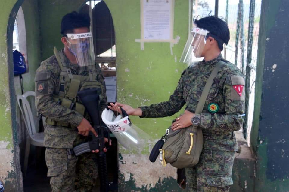 A soldier from the 1st Infantry Division in Labangan, Zamboanga del Sur distributes face shields to frontliners.  CONTRIBUTED PHOTO