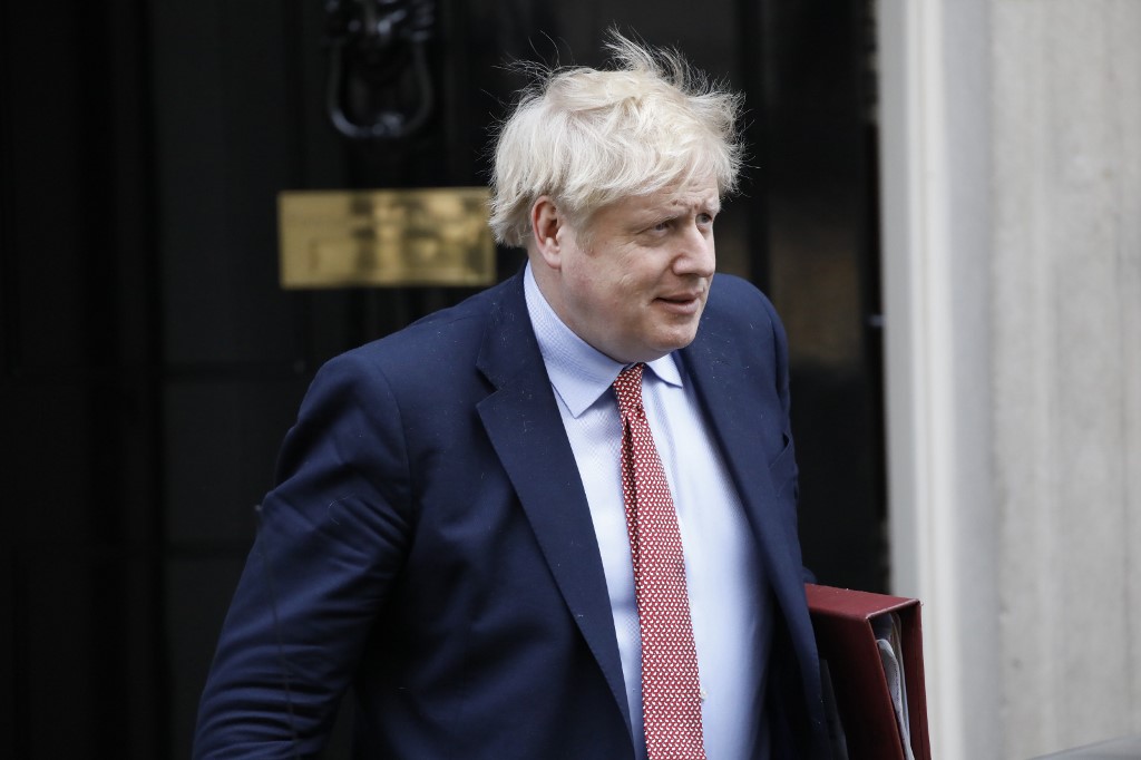Britain's Prime Minister Boris Johnson leaves number 10 Downing Street in central London on March 18, 2020, on his way to the House of Commons to attend Prime Minister's Questions (PMQs) - The British parliament is expected to close on Wednesday because of the coronavirus outbreak, with MPs sent home a week early for their Easter break. (Photo by Tolga AKMEN / AFP)