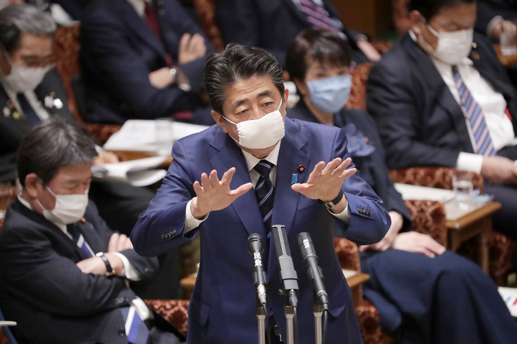 Japan's Prime Minister Shinzo Abe, wearing a face mask amid concerns over the spread of COVID-19 coronavirus, attends an upper house committee meeting at the parliament in Tokyo on April 1, 2020. (Photo by STR / JIJI PRESS / AFP) / Japan OUT