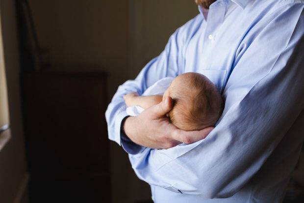 father holding newborn baby