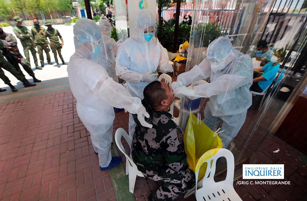 LOOK: Members of Philippine National Police (PNP) line up for swab specimen collection at the Caloocan City Hall on Wednesday, May 6, 2020, as mass testing continues to tackle the corona virus pandemic.-INQUIRER/GRIG C.MONTEGRANDE