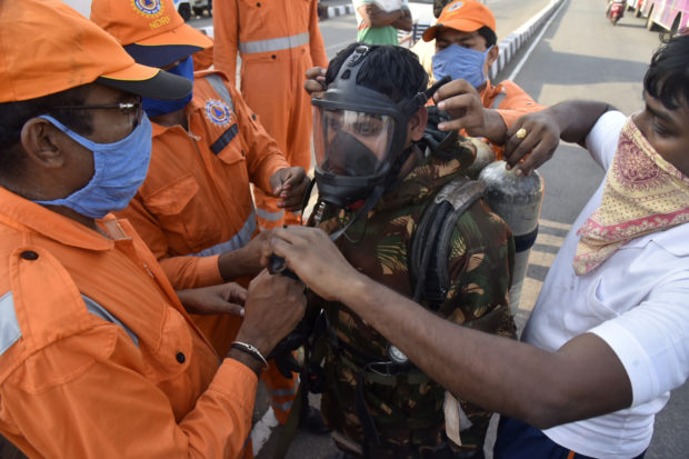A National Disaster Response Force (NDRF) soldier is fitted with gear before he proceeds to the area from where chemical gas leaked in Vishakhapatnam, India, Thursday, May 7, 2020.