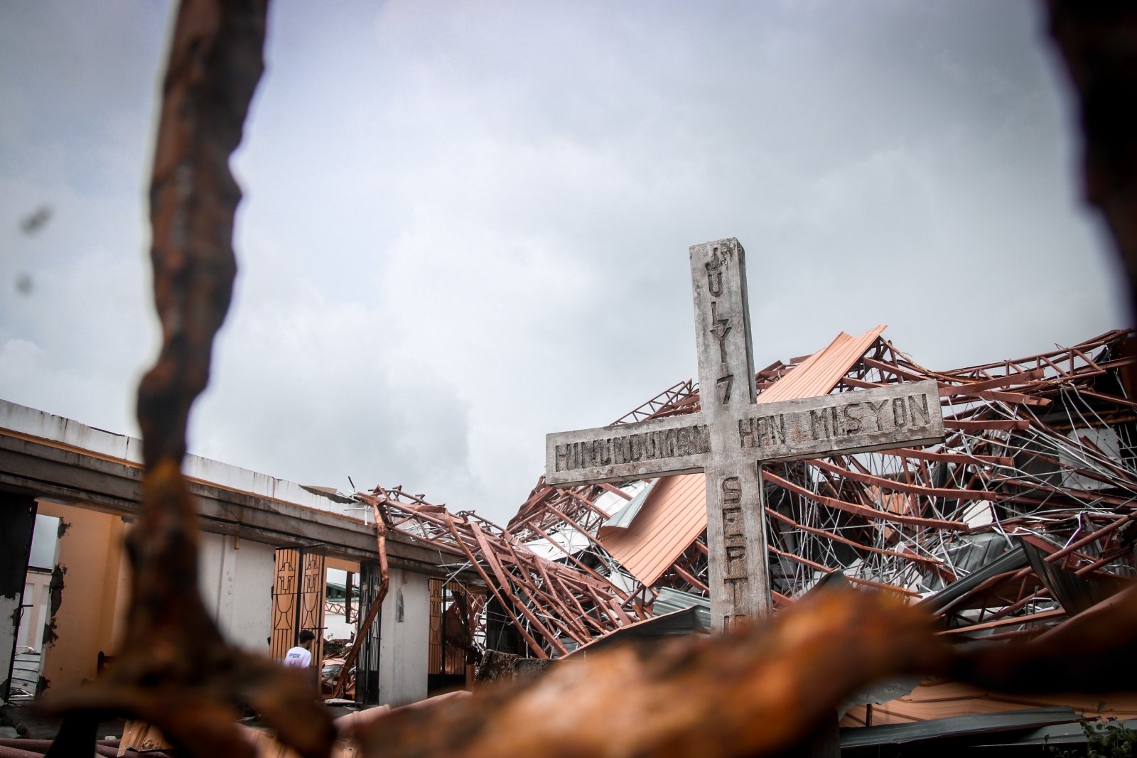 HARDEST HIT A solitary cross stands amid the debris of this roofless Catholic church in Arteche, Eastern Samar, the province hardest hit by Typhoon “Ambo” (international name: Vongfong). Ambo’s gusts of up to 185 kilometers per hour when it made landfall on the province on Thursday tore off the roof, leaving grey rain clouds hovering above the church dedicated to St. Raymond Nonnatus, patron saint of pregnant women. —PHOTO COURTESY OF EASTERN SAMAR GOV. BEN EVARDONE