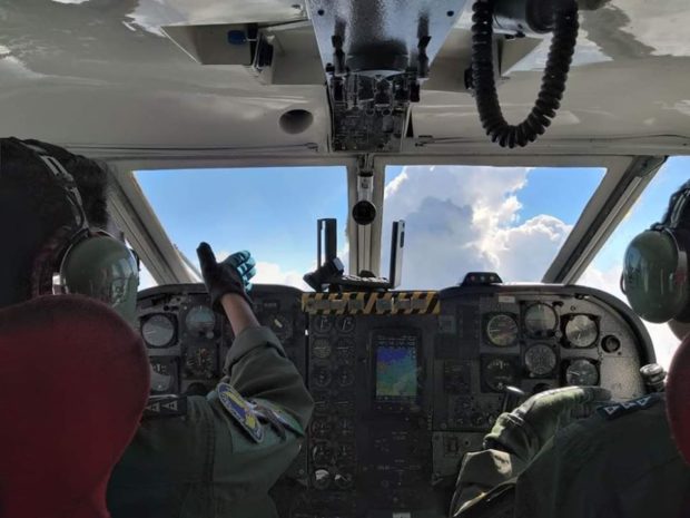 PHOTO: PAF cloud seeding plane view from behind pilots in cockpit STORY: PAF cloud seeding ops help contain Benguet forest fire