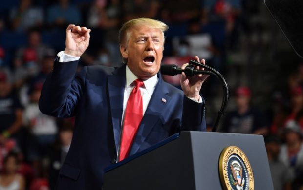 US President Donald Trump speaks during a campaign rally at the BOK Center on June 20, 2020 in Tulsa, Oklahoma. - Hundreds of supporters lined up early for Donald Trump's first political rally in months, saying the risk of contracting COVID-19 in a big, packed arena would not keep them from hearing the president's campaign message. (Photo by Nicholas Kamm / AFP)