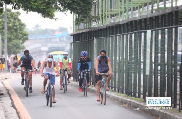 LOOK: Bikers pass through a special lane for riders along Commonwealth Avenue in Quezon City, during a 3-day road sharing exercise implemented by the MMDA on Saturday, June 27, in an effort to help workers commuting to work with limited public transportation now seen as the new normal. Niño Jesus Orbeta/Philippine Daily Inquirer