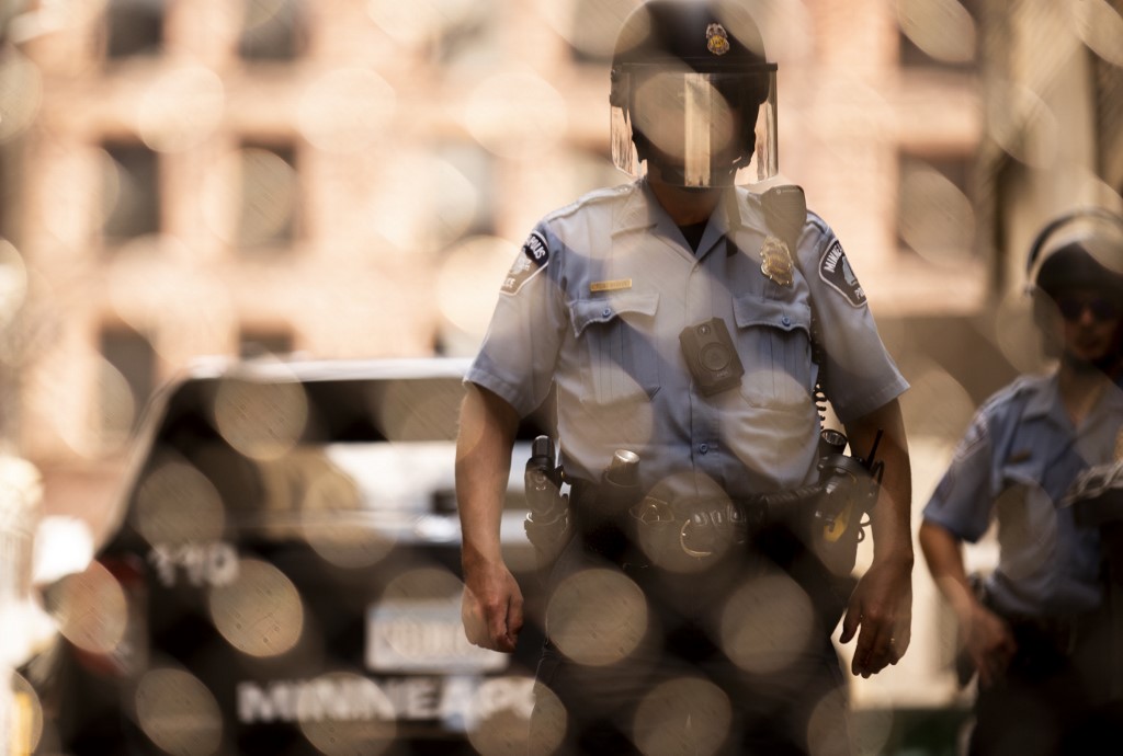 MINNEAPOLIS, MN - JUNE 13: Members of the Minneapolis Police Department seen through a chain link gate on June 13, 2020 in Minneapolis, Minnesota. The MPD has been under scrutiny from residents and local city officials after the death of George Floyd in police custody on May 25.   Stephen Maturen/Getty Images/AFP