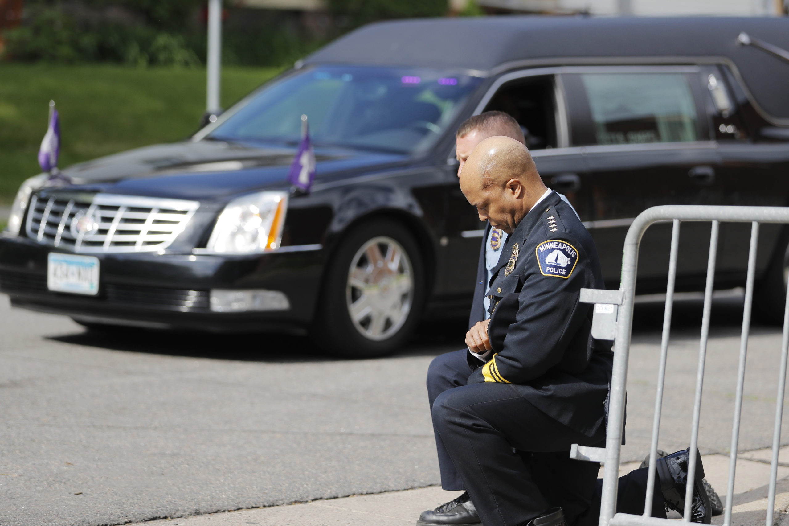 FILE - In this June 4, 2020, file photo, police officers including Minneapolis Police Chief Medaria Arradondo, foreground, take a knee as the body of George Floyd arrives before his memorial services in Minneapolis. In the two weeks since Floyd’s killing, police departments have banned chokeholds, Confederate monuments have fallen and officers have been arrested and charged. The moves come amid a massive, nationwide outcry against violence by police and racism. (AP Photo/Julio Cortez, File)
