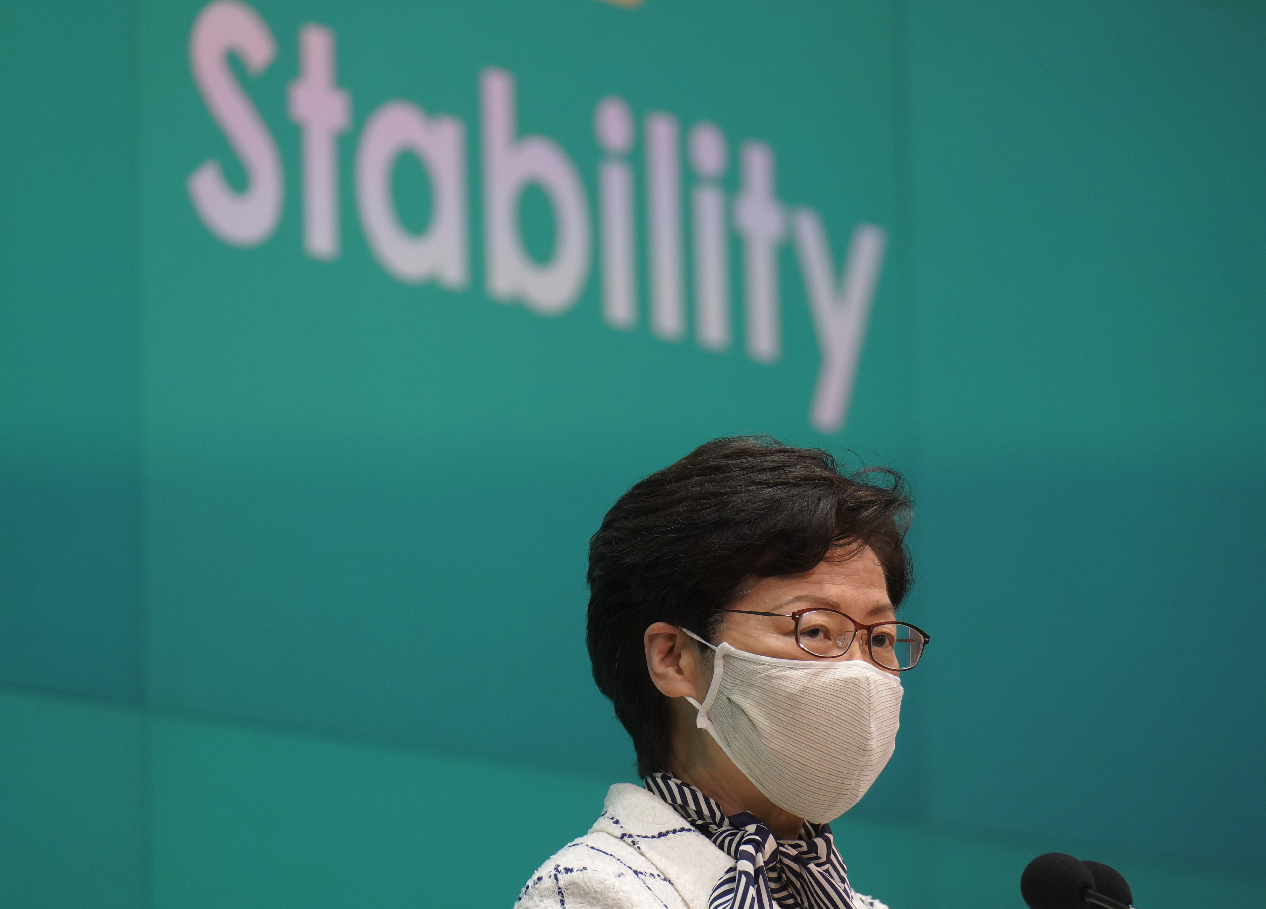 Hong Kong Chief Executive Carrie Lam listens to reporters questions during a press conference in Hong Kong, Tuesday, June 16, 2020.  Lam urged people to support a controversial national security law to be imposed by Beijing, while at the same time confessing that she couldn't explain the details of it.(AP Photo/Vincent Yu)