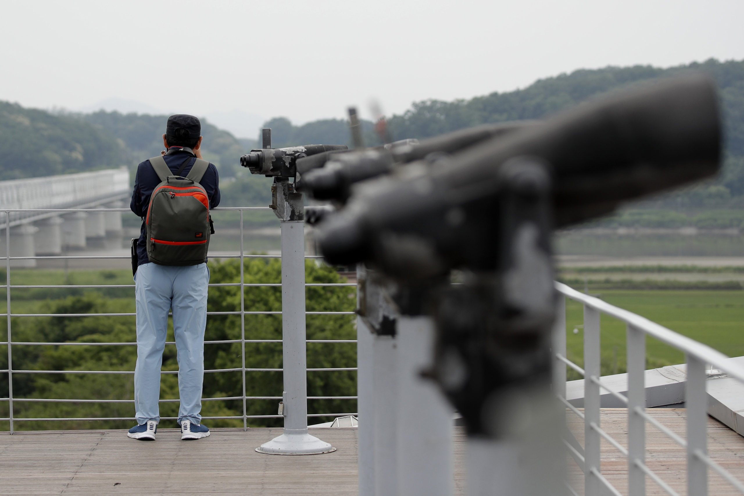 A visitor watches the northern side from the Imjingak Pavilion in Paju, South Korea, Thursday, June 18, 2020. Relations between the Koreas have been strained since a second Kim-Trump summit in early 2019 fell apart due to wrangling over the sanctions. (AP Photo/Lee Jin-man)