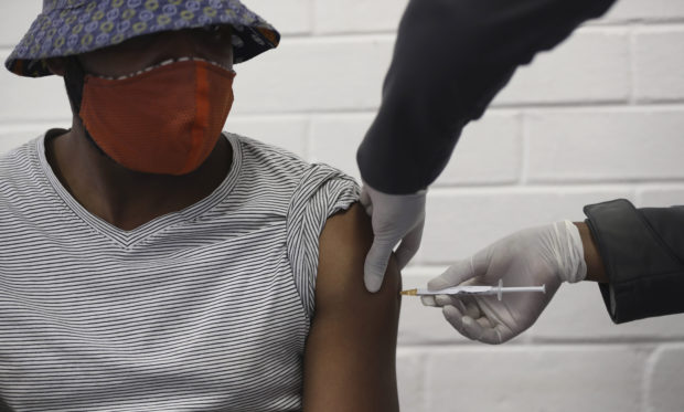 A vaccine volunteer gets an injection at the Chris Hani Baragwanath hospital in Soweto, Johannesburg Wednesday, June 24, 2020. Africa’s first participation in a COVID-19 vaccine trial has begun as volunteers received injections developed at the University of Oxford in Britain. The large-scale trial is being conducted in South Africa, Britain and Brazil. (AP Photo/Siphiwe Sibeko)