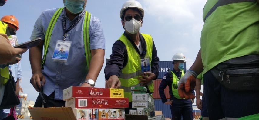 Personnel of the Bureau of Customs - Port of Manila seize on Wednesday, June 3, 2020, around P17.38 million worth of fake cigarettes that arrived from China on May 22. (Photo from BOC)