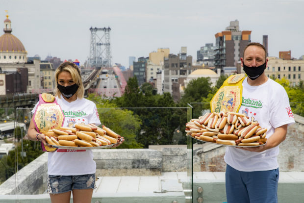 Competitive eaters Miki Sudo, left, and Joey Chestnut, right, pose for a photograph after a weigh-in before the Nathan's Famous July Fourth hot dog eating contest, Friday, July 3, 2020, in the Brooklyn borough of New York. 