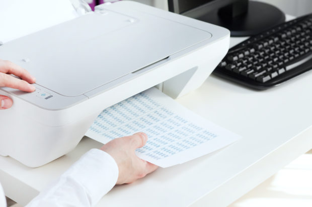 Man takes out some documents from printer