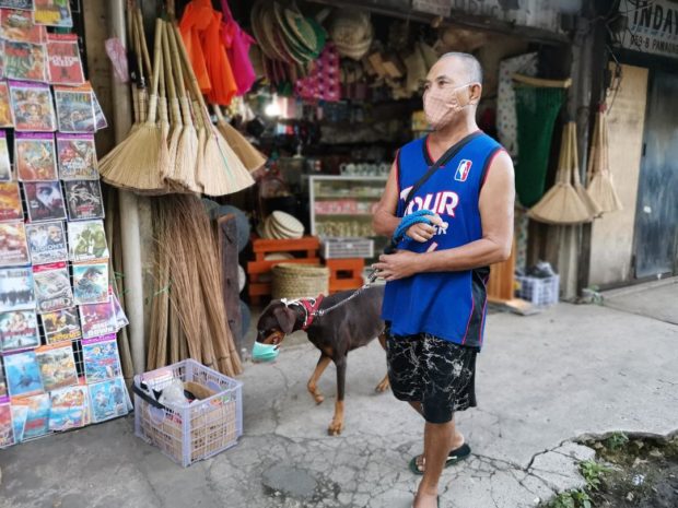 A man and his dog wear a face mask in Barangay Cogon, Tagbilaran City, Bohol to prevent the spread of the new coronavirus disease (COVID-19). (LEO UDTOHAN/INQUIRER VISAYAS)