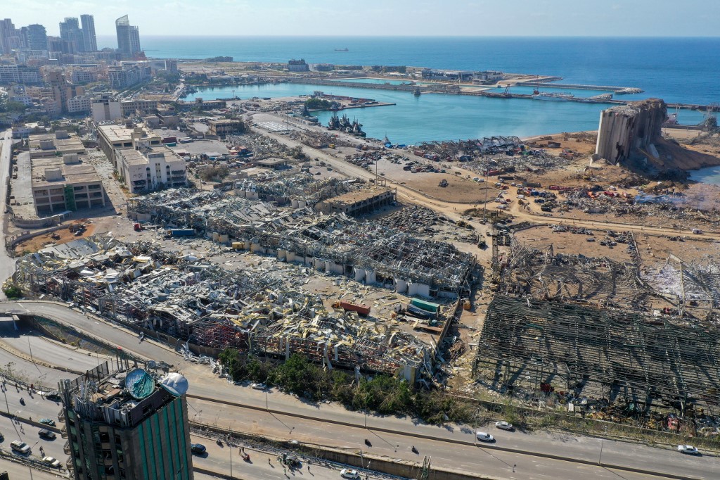 An aerial view shows the massive damage done to Beirut port's grain silos (C) and the area around it on August 5, 2020, one day after a mega-blast tore through the harbour in the heart of the Lebanese capital with the force of an earthquake, killing more than 100 people and injuring over 4,000. - Rescuers searched for survivors in Beirut in the morning after a cataclysmic explosion at the port sowed devastation across entire neighbourhoods, killing more than 100 people, wounding thousands and plunging Lebanon deeper into crisis. (Photo by - / AFP)