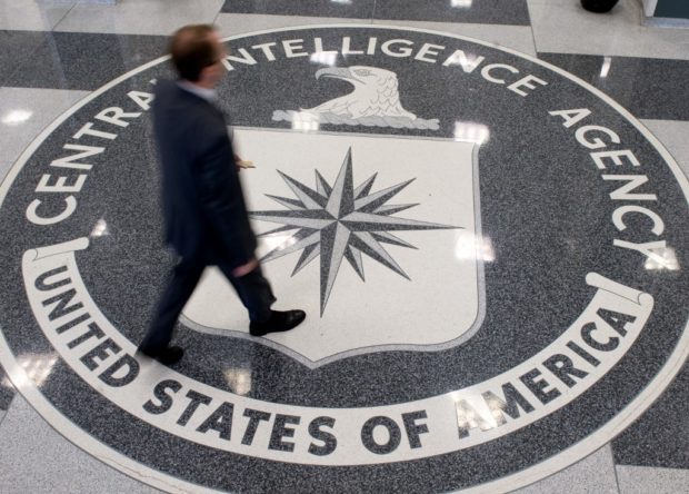 A man crosses the Central Intelligence Agency (CIA) seal in the lobby of CIA Headquarters in Langley, Virginia, on August 14, 2008. STORY: In new video, CIA urges Russians to leak ‘the truth’