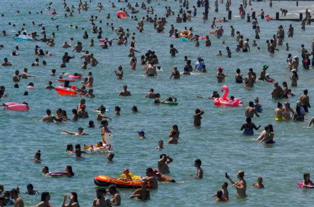 FILE PHOTO: People enjoy the hot weather at the beach in Bournemouth