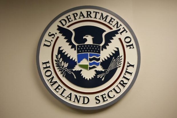 Two men tied to the U.S. Department of Homeland Security have been charged for spying on behalf of the Chinese government