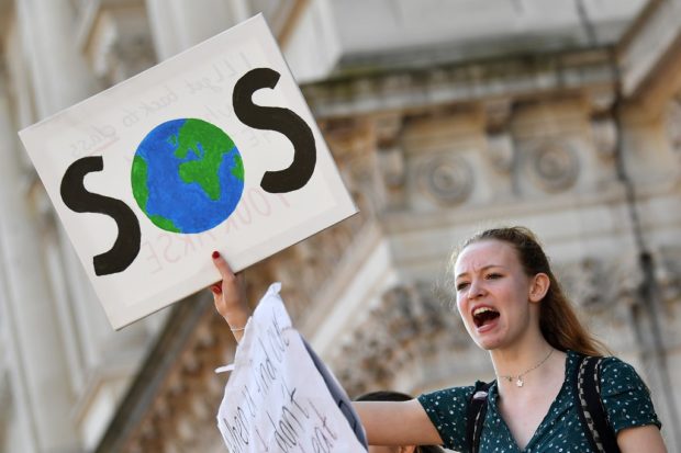 (FILES) In this file photo taken on February 15, 2019 young demonstrators hold placards as they attend a climate change protest organised by "Youth Strike 4 Climate", on Whitehall in central London. - The Pope and Prince William will join activists, artists, celebrities and politicians on Saturday at a free streamed TED event aimed at unifying people to confront the climate crisis. The Countdown program will kick off on the TED channel at YouTube starting at 8 AM in California and feature 50 speakers, the pontiff and the second-in-line to the British throne among them. (Photo by Ben STANSALL / AFP)