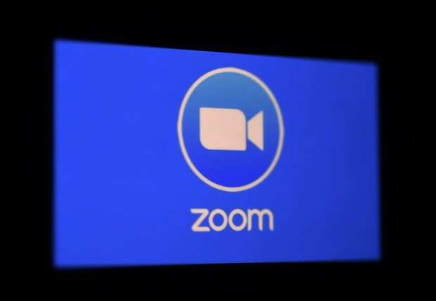  In this file photo illustration a Zoom App logo is displayed on a smartphone on March 30, 2020 in Arlington, Virginia. - The fast-growing online video app Zoom said on October 14, 2020 it would open its platform to paid events to help performers, teachers and others monetize their activity. The announcement of the new service called OnZoom comes after a similar initiative by Facebook to help people and groups unable to hold in-person events because of pandemic restrictions. 