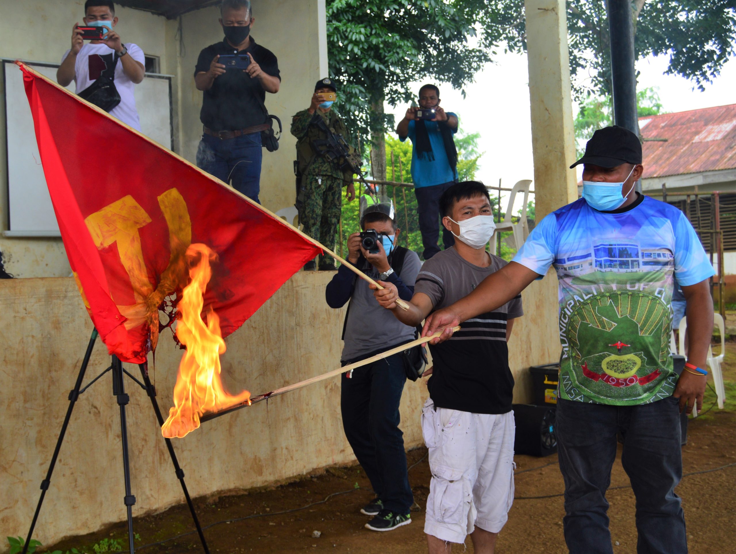 INDIGNATION. A resident of Claveria, Misamis Oriental burns a flag of the New People’s Army during a rally that condemned rebel atrocities in the town. (Jigger J. Jerusalem)