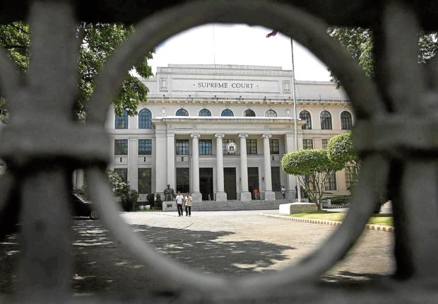 File photo of the Supreme Court building as viewed from its closed gateway. STORY: DOJ, SolGen should settle disputes among gov’t agencies – SC