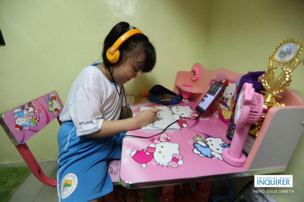 PHOTO: Grade 2 pupil Danielle B. Santos prepares for her first day of classes in their home in Barangay Tejeros, Makati City, on Monday, October 5, 2020. STORY: Gatchalian tells schools to go on blended learning amid hot weather