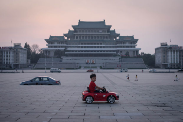 kim il-sung square Pyongyang child riding red car