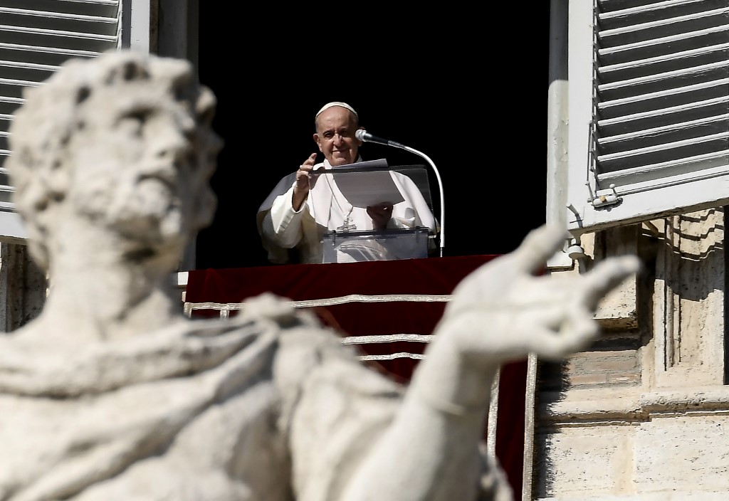 Pope Francis blesses worshippers as he delivers the Sunday Angelus prayer from the window of his study overlooking St.Peter's Square, at the Vatican on November 1, 2020 during the Covid-19 pandemic, caused by the novel coronavirus. (Photo by Filippo MONTEFORTE / AFP)