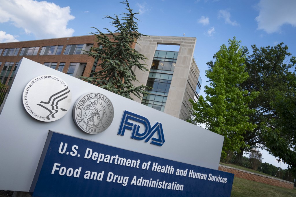 (FILES) In this file photo taken on July 20, 2020 a sign for the Food And Drug Administration is seen outside of the headquarters in White Oak, Maryland. - A Covid-19 antibody therapy used to treat President Donald Trump was approved by the US drug regulator on November 21 for people who aren't yet hospitalized by the disease but are at high risk. The green light for drugmaker Regeneron came after REGEN-COV2, a combination of two lab-made antibodies, was shown to reduce Covid-19-related hospitalizations or emergency room visits in patients with underlying conditions. (Photo by Sarah Silbiger / GETTY IMAGES NORTH AMERICA / AFP)