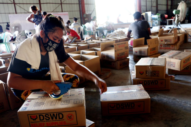 DSWD workers packing relief goods. STORY: DSWD to launch operations manual for emergency cash transfers on Monday