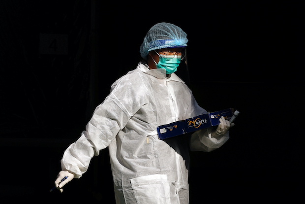 Hong Kong health worker in a protective suit