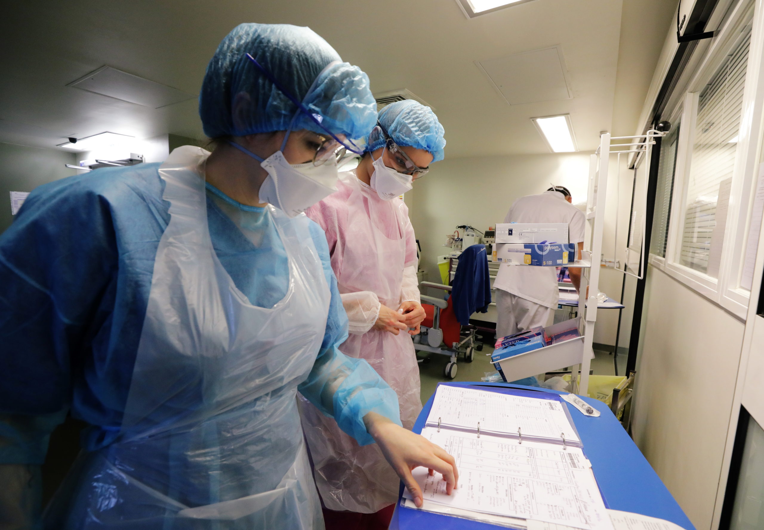 French hospital faces second wave of COVID-19 patients FILE PHOTO: Medical staff members work in the Intensive Care Unit (ICU) where patients suffering from the coronavirus disease (COVID-19) are treated at the Pasteur hospital in Nice, France, November 27, 2020. REUTERS/Eric Gaillard