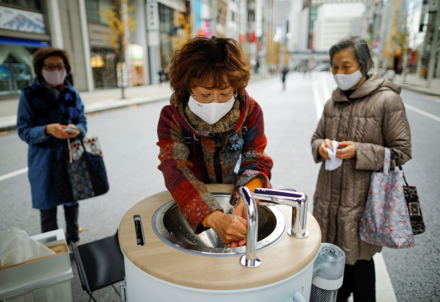Ginza shoppers clean hands, phones with hightech wash stations