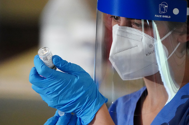 Nurse with vial of COVID-19 vaccine