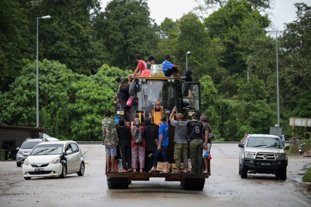 Malaysian villagers escape floods on excavator as 28,000 evacuated