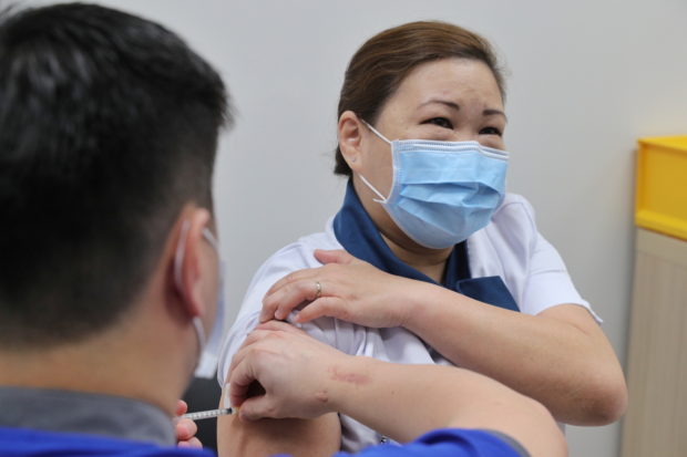 Singapore will consider relaxing curbs for vaccinated travelers – gov't exec
